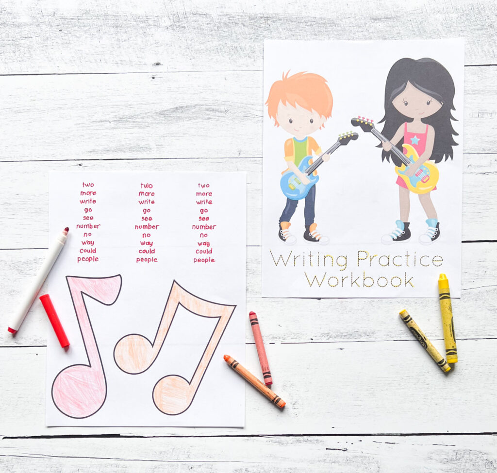 Cover page with two kids playing guitars says Writing Practice Workbook printed out next to page with words for kids to trace. The music notes are colored pink. Crayons lay next to the paper.