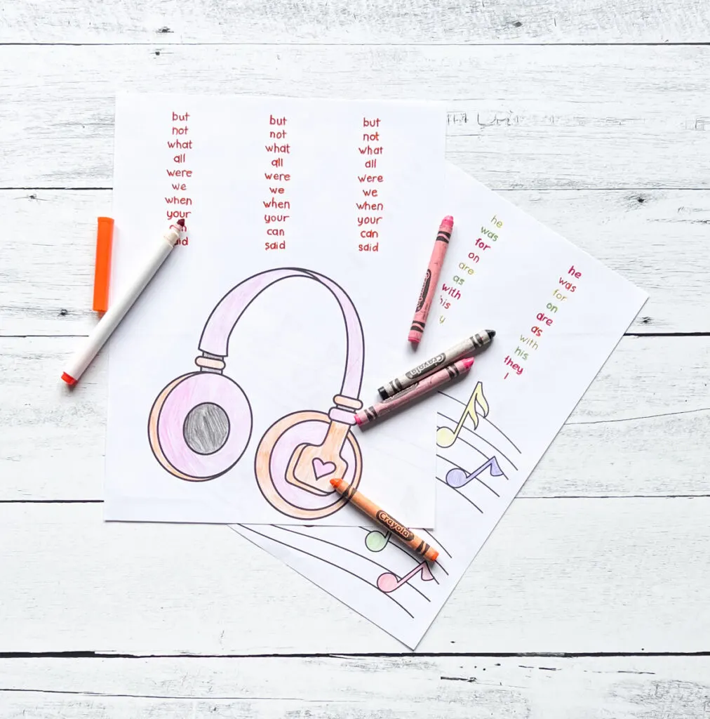 Page with picture of headphones for kids to color and sight words to trace. Markers and crayons lay on the pages.