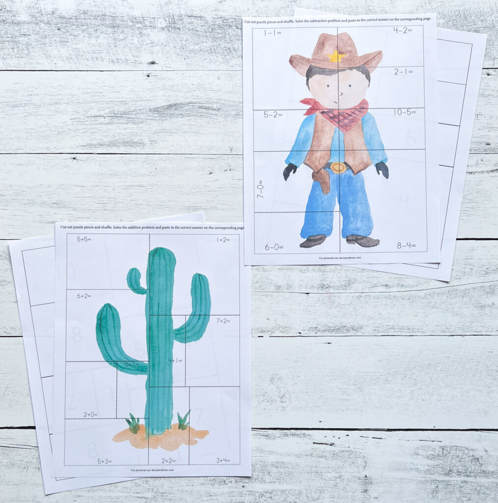 Cowboy and cactus math puzzle worksheets printed out and laying on white wood table.