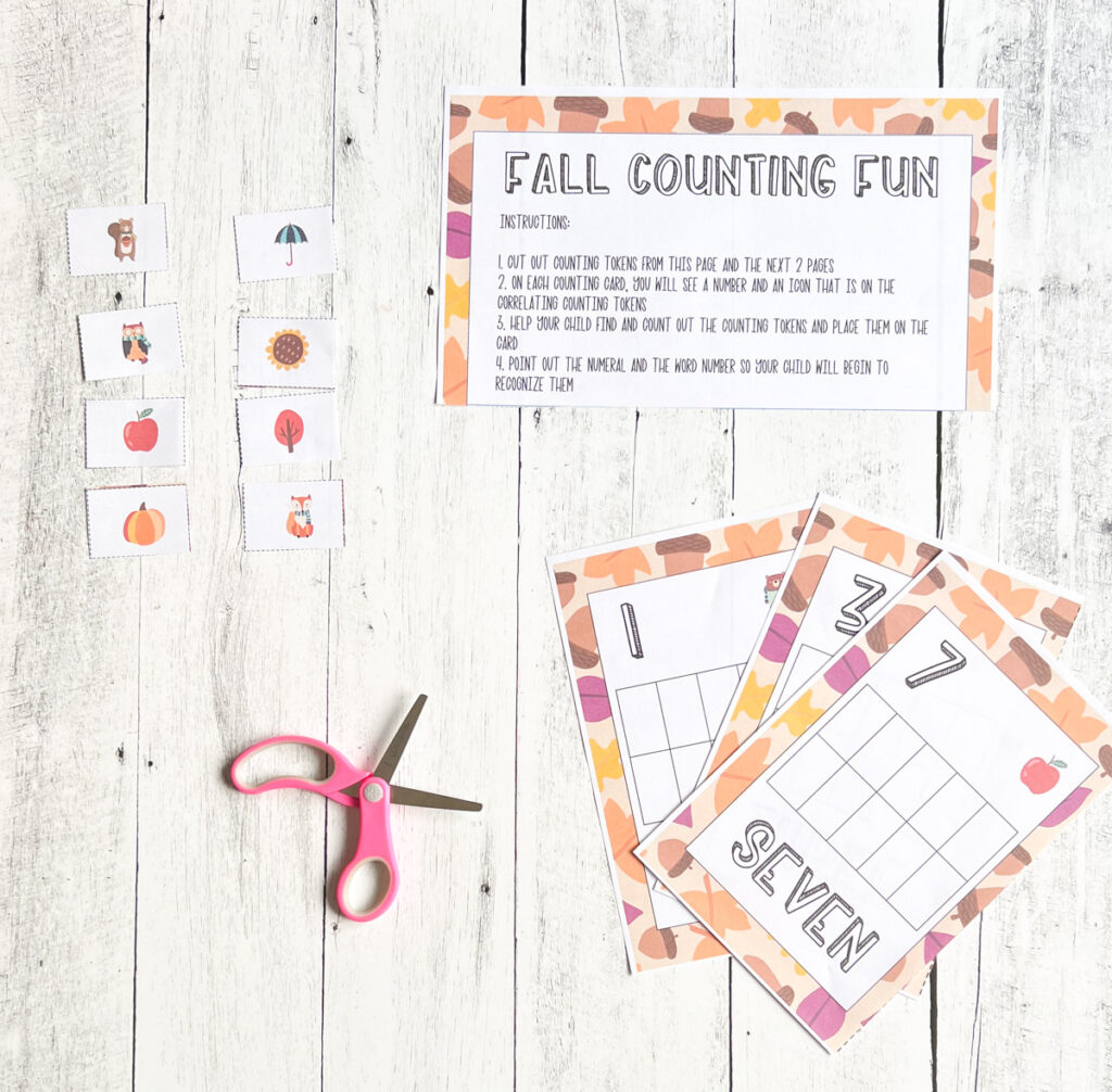 Pile of fall counting task cards fanned out beneath the activity directions. Square tokens with apples, leaves and squirrels lay next to them.