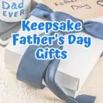 Blue text outlined with white says Keepsake Father's Day Gifts in the center over a background with a white gift box wrapped with a blue tie. A mug with "Best Dad Ever" is also in the background and a card envelope that says Happy Father's Day.