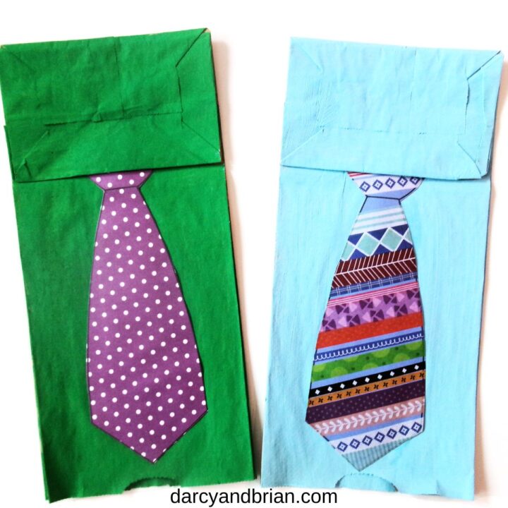 Two finished shirt and tie Father's Day crafts for kids. One green and purple and one blue with multi-colored pattern.