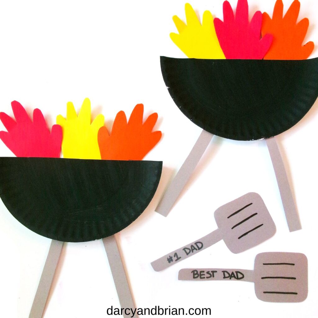 Painted paper plate cut in half to make two grills with red, yellow, and orange flames made by tracing kid hands.