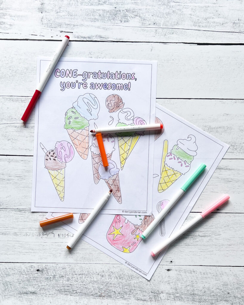 Page printed out with cones filled with ice cream and sprinkles to color in. Page on top says Cone-gratulations you're awesome! Markers lay on top of papers.