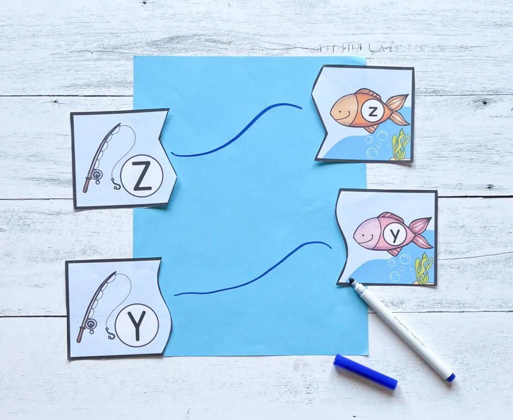 Uppercase and lowercase Z and Y fish-themed cards on either side of a blue paper. A blue marker was used to draw a line to the match.