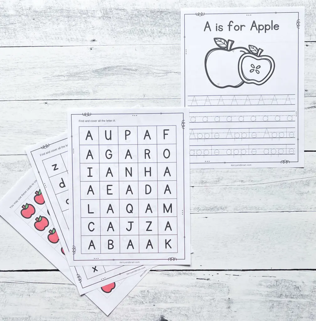 All of the pages printed out for this activity. One page for tracing the letter a and the word apple. Two pages for letter search. And one page with red apple markers to cut out and cover the As on the letter hunt pages.