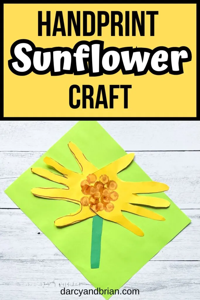 Black and white text on yellow background at the top says Handprint Sunflower Craft. A sunflower made using construction paper and tracing hands for petals laying on bright green paper.