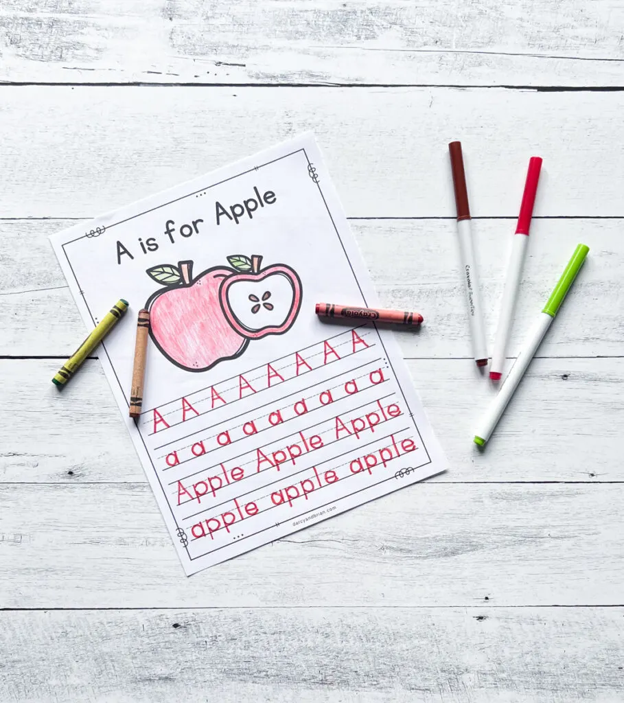 Worksheet with A is for Apple written at the top. Picture of an apple colored red with crayon. Upper and lowercase Aa and the word "apple" traced with red marker.