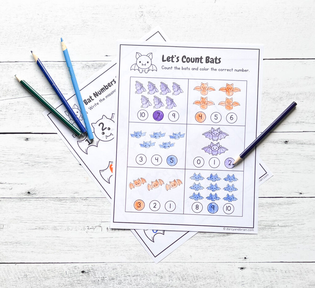 Two pages printed out and filled in with crayons and colored pencils. Top worksheet focuses on counting different quantities of bats.