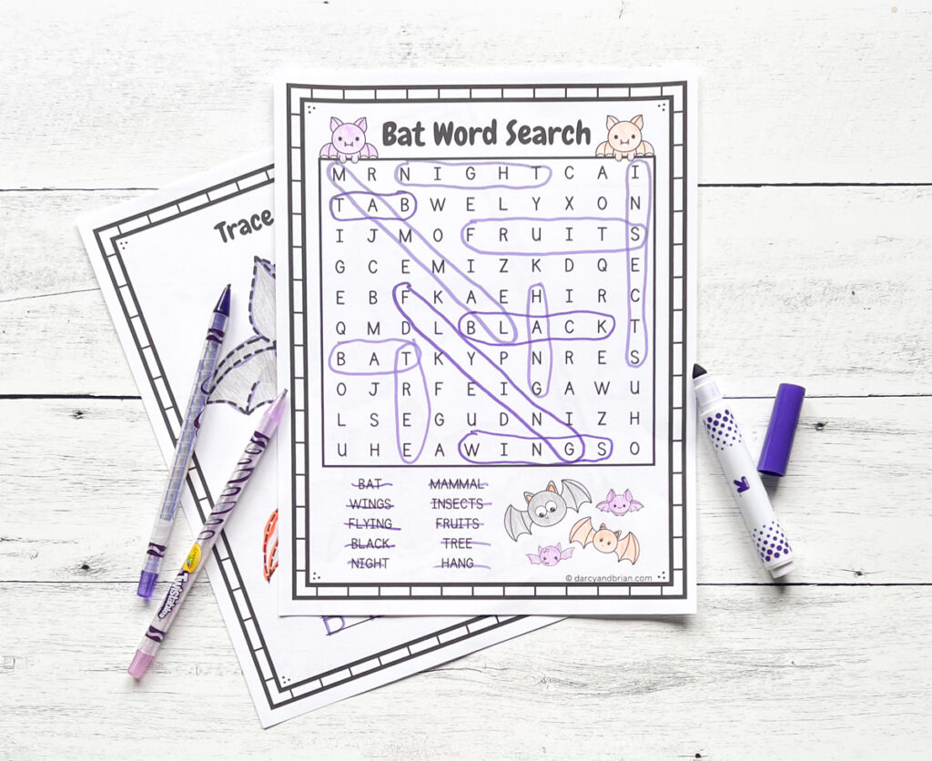 Completed bat themed word search page. Crayons and markers lay by the papers.