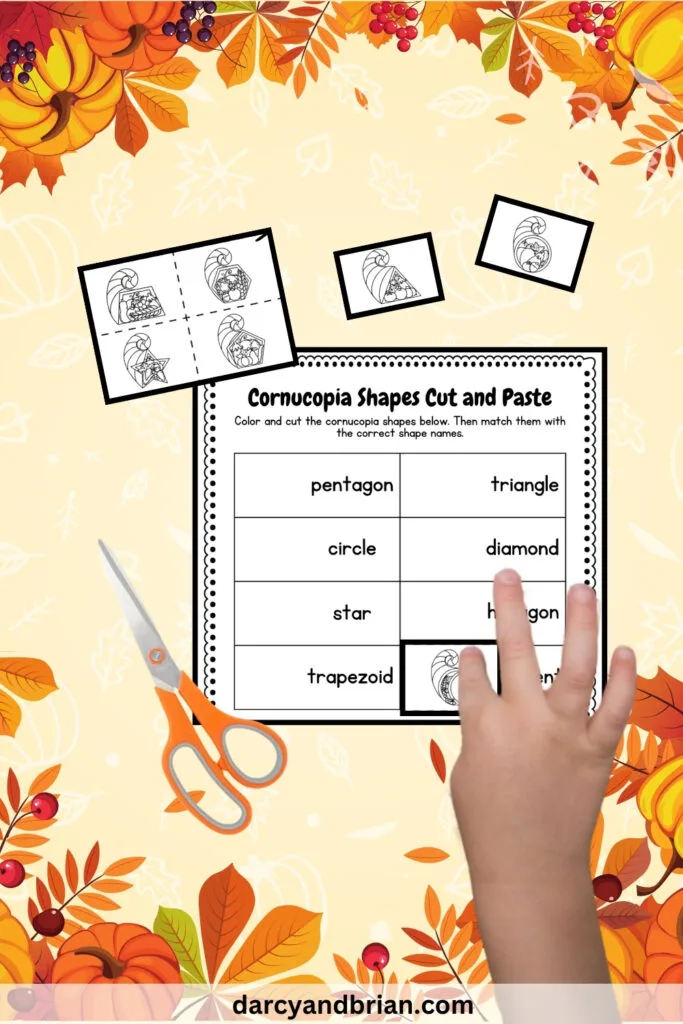 There is a worksheet with scissors and some cut images with shapes placed in a light background with colorful leaves and pumpkins.