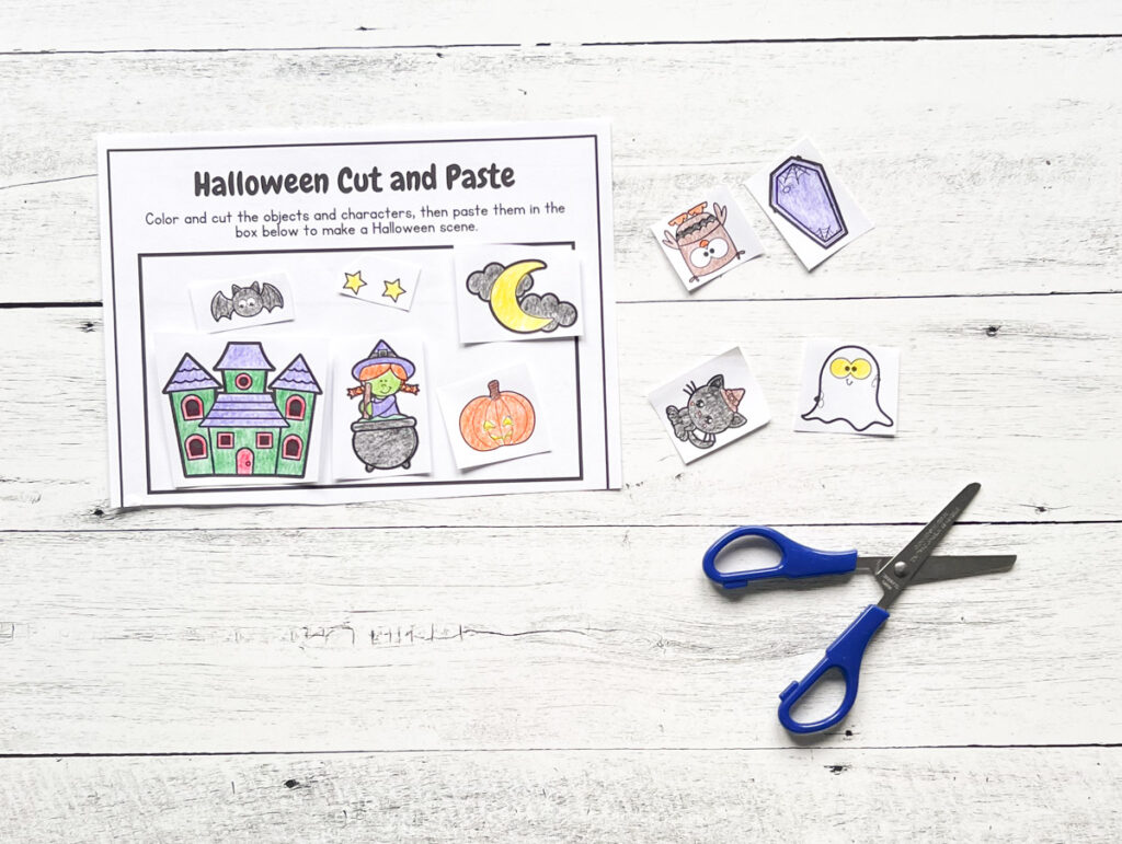 Activity page with haunted house and other items colored in, cut out, and glued to the worksheet.