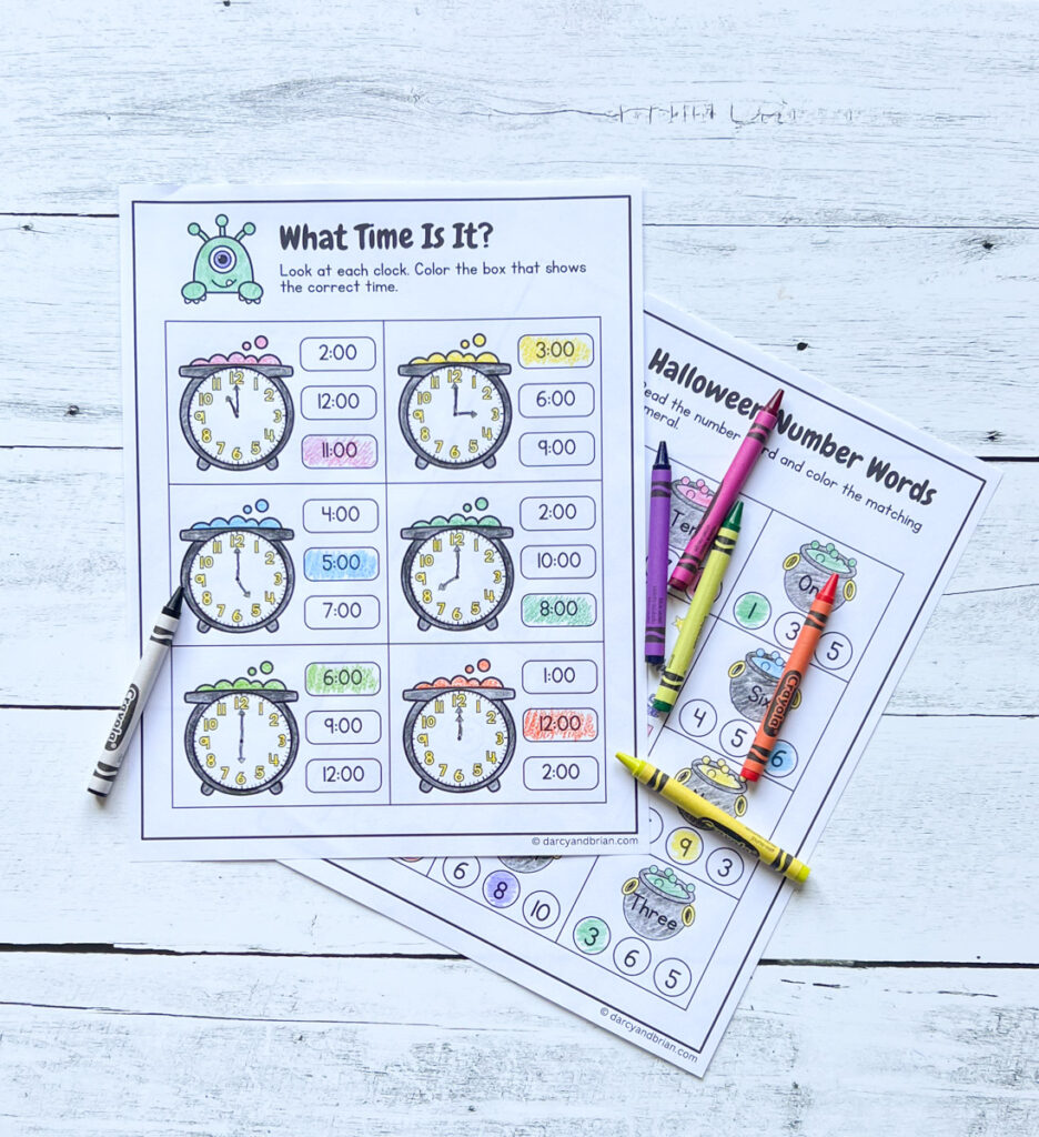 Halloween themed math activity page with clocks on cauldrons. The time answers are colored in with different crayons.