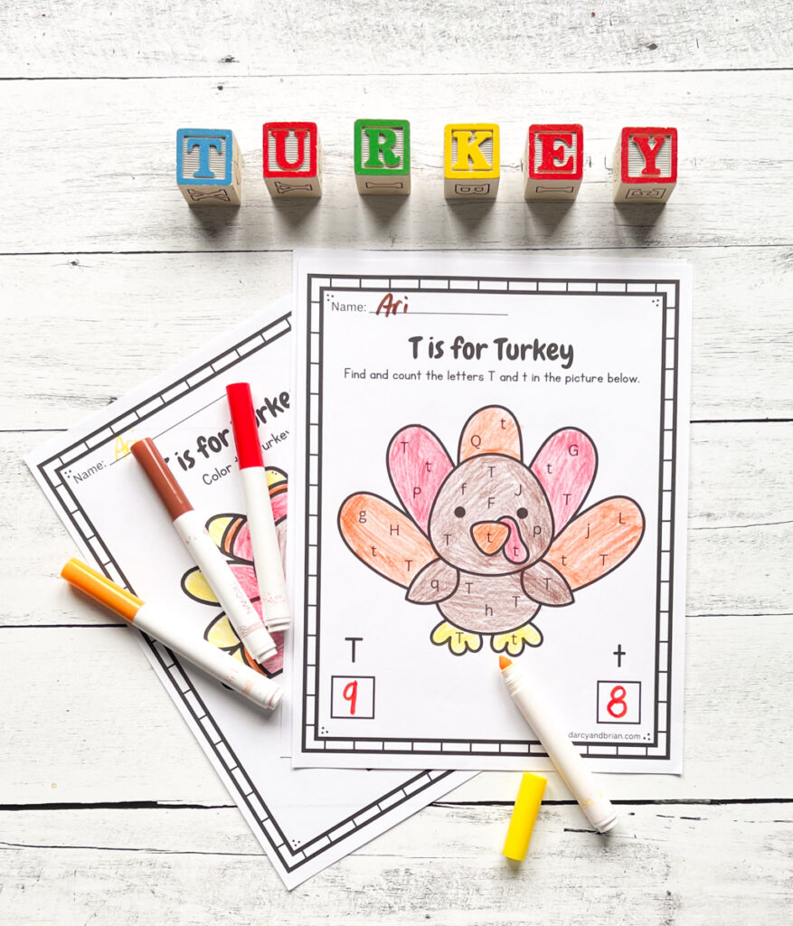 Finished worksheet with a cute turkey colored in and count how many uppercase T and lowercase t are in the picture. Markers lay by the page and children's alphabet blocks spell out "turkey" along the top.