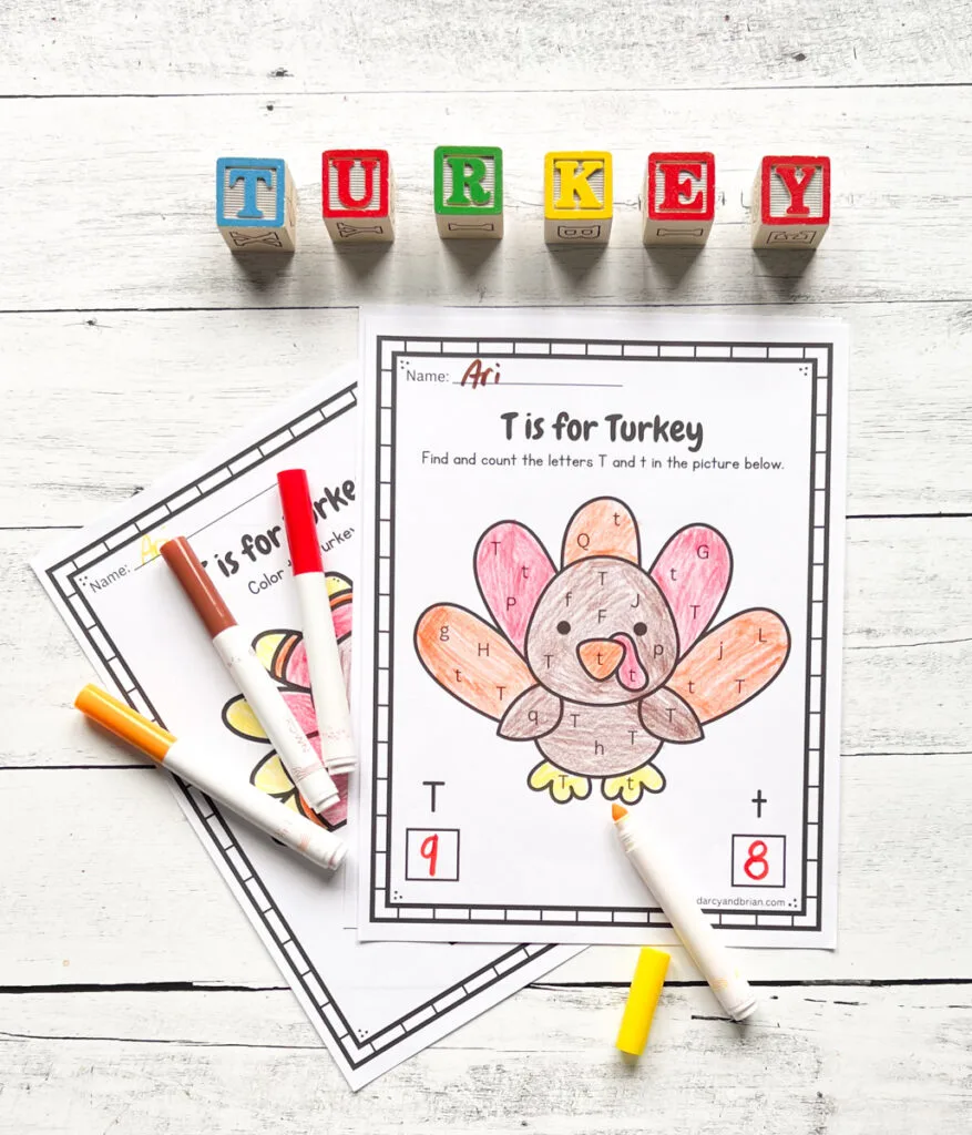 Finished worksheet with a cute turkey colored in and count how many uppercase T and lowercase t are in the picture. Markers lay by the page and children's alphabet blocks spell out "turkey" along the top.