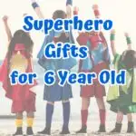 Blue text says Superhero Gifts for 6 Year Old over a picture of four children wearing capes and raising their hands in the air while standing on the beach.