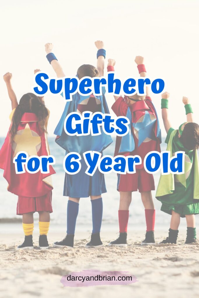 Blue text says Superhero Gifts for 6 Year Old over a picture of four children wearing capes and raising their hands in the air while standing on the beach.