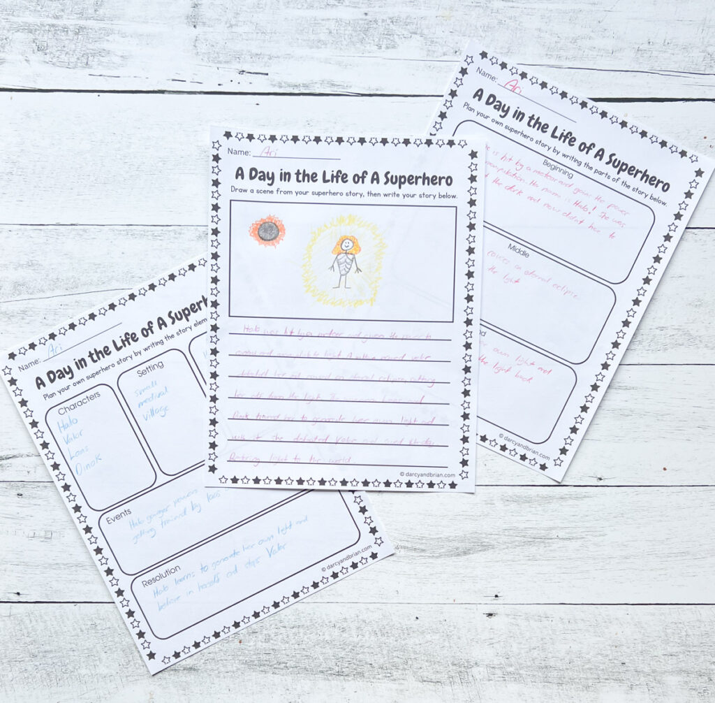 There are three pages of worksheets that kids can express themselves through drawing and writing about being a hero laying on a black and white wood background.