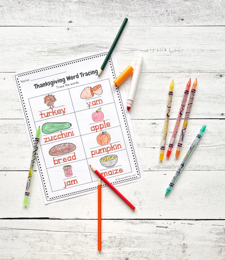 Page with colored in pictures of Thanksgiving dinner food items and the word for each one traced underneath. Twistable crayons lay by the paper.