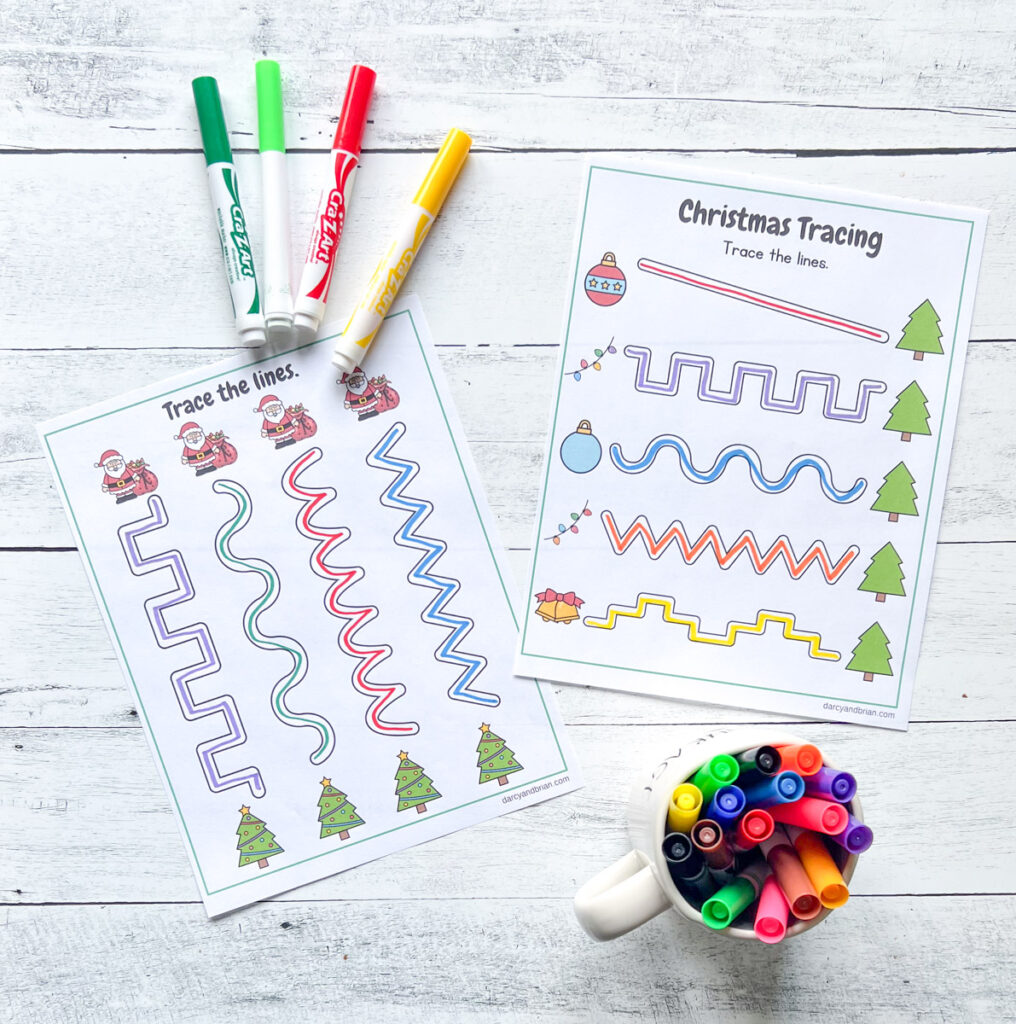 Two pages of tracing pages with different shaped lines leading to different Christmas trees which can be traced horizontally or vertically, along with markers on the background.