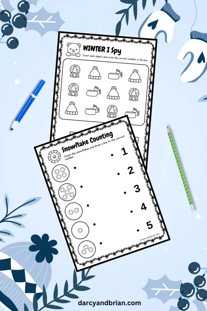 There are two pages of I Spy and Snowflake Counting with a pencil and blue marker placed in a snowy background with winter objects.